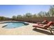 Private pool with lounge chairs, desert landscaping, and a brick privacy wall at 10731 E Texas Ave, Mesa, AZ 85212