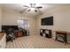 Home office with checkered carpet, ceiling fan, and ample workspace at 1270 W Beacon Ct, Casa Grande, AZ 85122