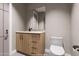 Guest bathroom with a wood vanity, modern fixtures, and a toilet at 14521 E Corrine Dr, Scottsdale, AZ 85259