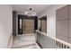 Welcoming entryway with a modern chandelier, wood staircase, and stylish front door at 14521 E Corrine Dr, Scottsdale, AZ 85259