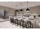 Modern kitchen with an island, bar seating, stainless steel appliances, and neutral cabinetry at 14521 E Corrine Dr, Scottsdale, AZ 85259