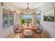 Dining area with large windows, wood table, and modern light fixture at 15040 N Greenhurst Ave, Fountain Hills, AZ 85268