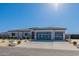 Attractive single-story home with a three-car garage and desert landscaping at 1763 W Caramel Ct, Queen Creek, AZ 85144