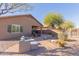 Relaxing backyard with a paved patio, desert landscaping, and comfortable seating at 1802 W Morse Dr, Anthem, AZ 85086