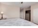 Main bedroom featuring carpeted floors, ceiling fan, and a dresser with a TV at 1802 W Morse Dr, Anthem, AZ 85086