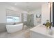 Bright bathroom with soaking tub, glass shower, and double vanity at 1805 W Caramel Ct, Queen Creek, AZ 85144