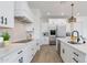White kitchen with an island, stainless steel appliances, and sleek black hardware at 1805 W Caramel Ct, Queen Creek, AZ 85144