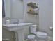 Powder room featuring a pedestal sink, toilet, and decorative shelving at 23123 E Via Del Sol --, Queen Creek, AZ 85142