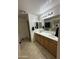 Spacious primary bathroom with dual sink vanity, large mirror, and tile flooring at 300 S 151St Ave, Goodyear, AZ 85338