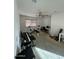 Bedroom used as a home gym and office with exercise equipment and a desk at 300 S 151St Ave, Goodyear, AZ 85338