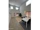 Dining room with high ceilings, wood floors, and a white dining table at 300 S 151St Ave, Goodyear, AZ 85338