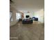 Living room with tile flooring, a couch, and a large window at 300 S 151St Ave, Goodyear, AZ 85338
