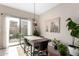 Dining area with sliding glass doors, modern light fixture, and stylish decor at 3656 W Bryce Ct, Phoenix, AZ 85086