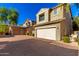 Exterior view of a home with attached garage and paved driveway at 3656 W Bryce Ct, Phoenix, AZ 85086