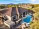 Aerial view of home with pool, spa, putting green, and desert landscaping at 36701 N Porta Nuova Rd, Scottsdale, AZ 85262