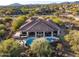 Elevated view of the home's exterior, pool, and surrounding desert landscape at 36701 N Porta Nuova Rd, Scottsdale, AZ 85262