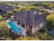 Expansive aerial view showcasing the home's tile roof, pool, spa, and outdoor features at 36701 N Porta Nuova Rd, Scottsdale, AZ 85262