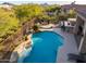 Backyard oasis with pool, waterfall, fire pit, and built-in grill at 36701 N Porta Nuova Rd, Scottsdale, AZ 85262