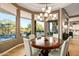 Breakfast nook with large windows, chandelier, and view of pool at 36701 N Porta Nuova Rd, Scottsdale, AZ 85262