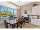 Bright breakfast nook with large window, chandelier, and view of backyard grill at 36701 N Porta Nuova Rd, Scottsdale, AZ 85262