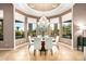 Breakfast nook with round table, white chairs, and large windows offering natural light at 36701 N Porta Nuova Rd, Scottsdale, AZ 85262