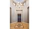 Foyer with high ceilings, a dark wood door, and tiled floor with an inlaid design at 36701 N Porta Nuova Rd, Scottsdale, AZ 85262