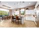 Spacious kitchen with white cabinets, island, breakfast bar, and stainless steel appliances at 36701 N Porta Nuova Rd, Scottsdale, AZ 85262