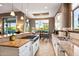 Open kitchen with large island, breakfast bar, and dining area at 36701 N Porta Nuova Rd, Scottsdale, AZ 85262