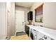 Laundry room with washer, dryer, sink, cabinets, and door to garage at 36701 N Porta Nuova Rd, Scottsdale, AZ 85262