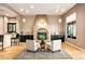 Living room with fireplace, wet bar, and ample seating area at 36701 N Porta Nuova Rd, Scottsdale, AZ 85262
