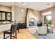 Inviting living area featuring a fireplace, built-in bar, and comfortable seating at 36701 N Porta Nuova Rd, Scottsdale, AZ 85262