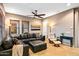 Living room with dark leather sectional sofa, recliner, and tile flooring at 36701 N Porta Nuova Rd, Scottsdale, AZ 85262
