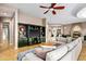Spacious living room with entertainment center, fireplace, and view of the kitchen and dining area at 36701 N Porta Nuova Rd, Scottsdale, AZ 85262