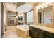 Luxurious main bathroom with double vanity, soaking tub, and tile flooring at 36701 N Porta Nuova Rd, Scottsdale, AZ 85262