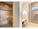 Main bathroom with tiled walk-in shower, vanity area, and modern fixtures at 36701 N Porta Nuova Rd, Scottsdale, AZ 85262
