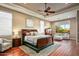 Spacious main bedroom with ceiling fan, wooden furniture, and large windows at 36701 N Porta Nuova Rd, Scottsdale, AZ 85262