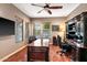 Home office with wood flooring, built-in desk and shelves, and large executive chair at 36701 N Porta Nuova Rd, Scottsdale, AZ 85262