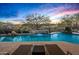Tranquil pool with waterfall feature and picturesque desert backdrop at 36701 N Porta Nuova Rd, Scottsdale, AZ 85262
