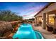 Inviting pool with waterfall feature and lush landscaping at 36701 N Porta Nuova Rd, Scottsdale, AZ 85262