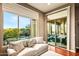 Cozy sitting area with large windows overlooking the backyard patio and pool at 36701 N Porta Nuova Rd, Scottsdale, AZ 85262