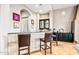 Elegant wet bar with stone accents and ample counter space at 36701 N Porta Nuova Rd, Scottsdale, AZ 85262