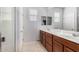 Bathroom with double vanity, large mirror, and shower at 36909 N Coronado Ln, San Tan Valley, AZ 85140