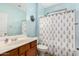 Clean bathroom with a shower/tub combo and wood vanity at 36909 N Coronado Ln, San Tan Valley, AZ 85140