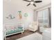 Bedroom with crib, armchair, and playful decor at 36909 N Coronado Ln, San Tan Valley, AZ 85140