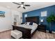 Spacious bedroom with dark wood furniture and blue accent wall at 36909 N Coronado Ln, San Tan Valley, AZ 85140