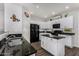 Modern kitchen with white cabinets, granite countertops, and island at 36909 N Coronado Ln, San Tan Valley, AZ 85140