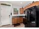 Modern kitchen with black appliances and wood cabinets at 36909 N Coronado Ln, San Tan Valley, AZ 85140