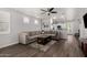 Open living space with L-shaped sofa, wood-look floors, and kitchen views at 36909 N Coronado Ln, San Tan Valley, AZ 85140