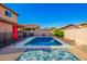 Sparkling pool with patio, fenced area, and umbrella at 36909 N Coronado Ln, San Tan Valley, AZ 85140