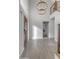 Foyer with wood-look tile floor, chandelier, staircase, and view to the living area at 4018 E Goldfinch Gate Ln, Phoenix, AZ 85044